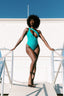 Teal one-piece swimsuit with deep split at the front on body 2